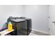 Laundry room with gray wood-look floors and front loading washer and dryer at 2491 Bracknell Forest Trl, Tavares, FL 32778