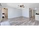 Spacious living room with new flooring and an open layout leading to the bedroom at 2491 Bracknell Forest Trl, Tavares, FL 32778