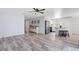 Open floor plan featuring new floors, kitchen island, and stainless steel appliances at 2491 Bracknell Forest Trl, Tavares, FL 32778