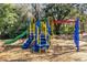 Colorful playground with a slide, stairs, and monkey bars, surrounded by mulch at 2491 Bracknell Forest Trl, Tavares, FL 32778