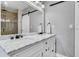 Elegant bathroom with a double vanity, marble countertop, modern fixtures, and a glass-enclosed shower at 2812 Mulford Ave, Winter Park, FL 32789