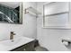 Bathroom with a gray vanity, modern faucet, decorative mirror and convenient towel rack at 2812 Mulford Ave, Winter Park, FL 32789