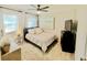 Cozy bedroom featuring a ceiling fan, light wood flooring, and a stylish beach-themed art piece at 2812 Mulford Ave, Winter Park, FL 32789