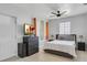 Cozy bedroom with a neutral palette, featuring a queen bed, dresser, and natural light at 2812 Mulford Ave, Winter Park, FL 32789