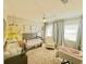 Charming Bedroom with a crib, rocking chair, and soft neutral tones for a calming environment at 2812 Mulford Ave, Winter Park, FL 32789