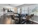 Open concept dining area showcasing a large table, modern chairs, and seamless flow into the kitchen at 2812 Mulford Ave, Winter Park, FL 32789