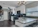 Contemporary kitchen with black appliances, granite countertops, white cabinets, and sleek modern lighting at 2812 Mulford Ave, Winter Park, FL 32789