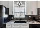 Kitchen detail showing granite countertops, stylish sink, stainless steel appliances, and ample counter space at 2812 Mulford Ave, Winter Park, FL 32789