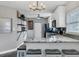 Modern kitchen featuring white cabinets, granite countertops, stainless steel appliances, and stylish lighting at 2812 Mulford Ave, Winter Park, FL 32789