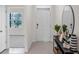 Bright foyer showcasing neutral tile flooring, a console table, and a white front door at 2829 Jamaica Way, Haines City, FL 33844