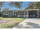 Inviting single-story home with carport, green siding, white trim, and a well-manicured lawn at 2942 Condel Dr, Orlando, FL 32812