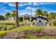 Beautiful amenities center sign and building surrounded by lush landscaping at 3128 Dark Sky Dr, Harmony, FL 34773