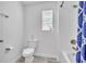 Clean bathroom featuring a toilet, bathtub with shower, and a window at 3128 Dark Sky Dr, Harmony, FL 34773