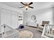 Bright Bedroom with a ceiling fan, white furniture, and a round alphabet rug at 3128 Dark Sky Dr, Harmony, FL 34773