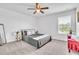 Comfortable bedroom with a modern ceiling fan, a plush bed, and a bright window at 3128 Dark Sky Dr, Harmony, FL 34773
