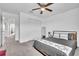 Bright bedroom with a ceiling fan, carpeted floors, and a closet for ample storage space at 3128 Dark Sky Dr, Harmony, FL 34773