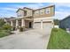 Two-story home featuring a two-car garage and a well-manicured front lawn at 3128 Dark Sky Dr, Harmony, FL 34773