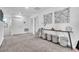 Bright hallway with carpet, white walls, a stylish console table, and decorative woven baskets at 3128 Dark Sky Dr, Harmony, FL 34773