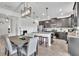 Open-concept kitchen with dark cabinets, granite countertops, stainless steel appliances, and large island at 3128 Dark Sky Dr, Harmony, FL 34773