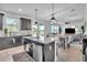 Bright open kitchen island with stone countertops and backyard views at 3128 Dark Sky Dr, Harmony, FL 34773
