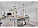 Kitchen island featuring stone countertops, stainless steel dishwasher, and seating overlooks dining area at 3128 Dark Sky Dr, Harmony, FL 34773