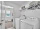 Well-lit laundry room featuring a washer, dryer, and overhead storage at 3128 Dark Sky Dr, Harmony, FL 34773