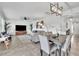 Open-concept living room with dining area features stylish decor and modern lighting at 3128 Dark Sky Dr, Harmony, FL 34773