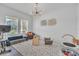 Bright, open living room featuring a modern light fixture and large windows at 3128 Dark Sky Dr, Harmony, FL 34773