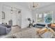Bright and airy living room featuring a modern light fixture and comfortable seating at 3128 Dark Sky Dr, Harmony, FL 34773