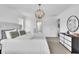 Bright main bedroom with a decorative light fixture, dresser, and comfortable, inviting bed at 3128 Dark Sky Dr, Harmony, FL 34773