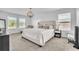 Spacious main bedroom featuring natural light from large windows and a plush, comfortable bed at 3128 Dark Sky Dr, Harmony, FL 34773