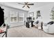 Well-lit home office space with a large window, ceiling fan, and comfortable seating at 3128 Dark Sky Dr, Harmony, FL 34773