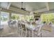 Outdoor covered lounge area with stone fireplace and comfortable seating near pool at 3128 Dark Sky Dr, Harmony, FL 34773