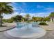 Large community swimming pool surrounded by palm trees and chairs at 3128 Dark Sky Dr, Harmony, FL 34773
