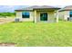 View of the house from the green backyard at 3219 Cup Dr, Lakeland, FL 33803