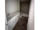 Bathroom features a tub, shower, toilet and a modern vanity with storage space at 3219 Cup Dr, Lakeland, FL 33803