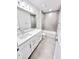Bathroom with tiled shower, tile floor, and white cabinets at 3219 Cup Dr, Lakeland, FL 33803