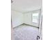 Bedroom featuring a window, carpet flooring, and neutral paint at 3219 Cup Dr, Lakeland, FL 33803