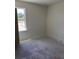 Well-lit bedroom with a view of green outdoor trees at 3219 Cup Dr, Lakeland, FL 33803