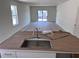 Modern kitchen island sink and faucet in an open layout, bathed in natural light at 3219 Cup Dr, Lakeland, FL 33803
