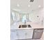 Kitchen island with stainless steel sink and view of the living room at 3219 Cup Dr, Lakeland, FL 33803