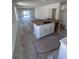 Open-concept kitchen with island overlooking a large living area with sliding glass doors at 3219 Cup Dr, Lakeland, FL 33803