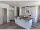 Bright, spacious kitchen featuring an island with a sink and ample cabinet storage at 3219 Cup Dr, Lakeland, FL 33803
