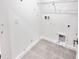 Laundry room with tiled floor, connections for washer and dryer, and wire shelving at 3219 Cup Dr, Lakeland, FL 33803