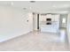 Open concept living room and kitchen with large tiles at 3219 Cup Dr, Lakeland, FL 33803