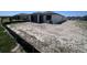 Wide view of the home's backyard, showing the patio, the new home, and surrounding landscape at 3352 Cup Dr, Lakeland, FL 33803