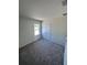 Cozy bedroom with plush gray carpeting and a window bringing in natural light at 3352 Cup Dr, Lakeland, FL 33803