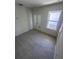 Bright bedroom with tile flooring, a window, and double closet doors at 3352 Cup Dr, Lakeland, FL 33803