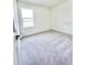 Cozy bedroom featuring a window that offers outside views and plush carpeting at 3352 Cup Dr, Lakeland, FL 33803