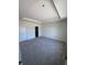 Spacious bedroom featuring soft carpeting and a tray ceiling with recessed lighting at 3352 Cup Dr, Lakeland, FL 33803